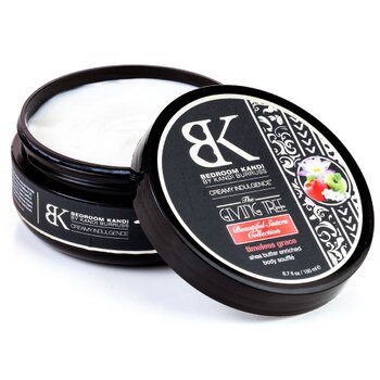 An image of an open jar of creamy indulgence body souffle in timeless grace fragrance. The cream inside the black jar is a thick whipped white mixture.